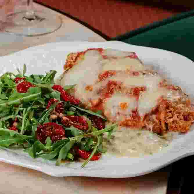 chicken-parmigiana-with-gribiche-sauce-and-arugula.webp