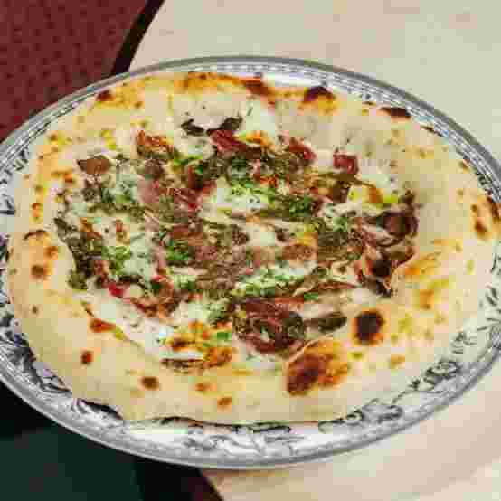 pizza-with-truffle-sauce-bacon-and-mushrooms.webp